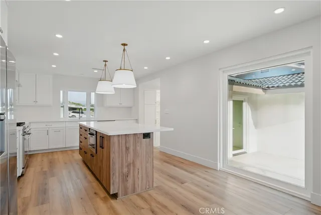 a kitchen with cabinets appliances a sink and a stove