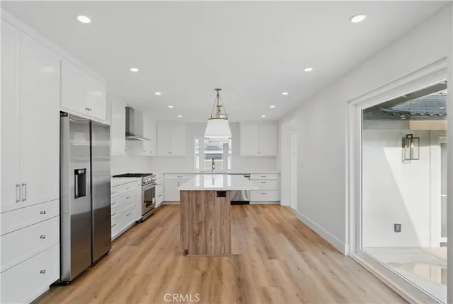 a kitchen with stainless steel appliances a stove and a refrigerator