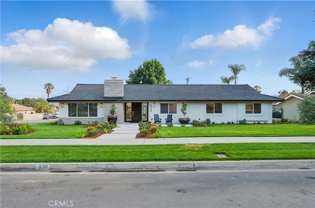 a front view of a house with a yard and table and chairs