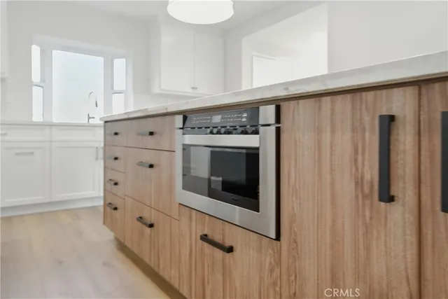 a kitchen with granite countertop a stove a sink and a refrigerator