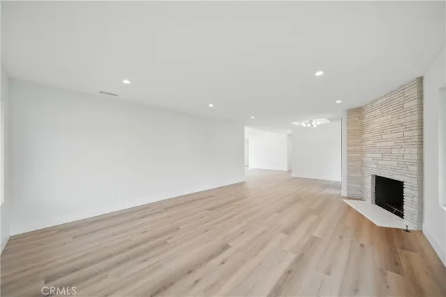 a view of an empty room with wooden floor and garden