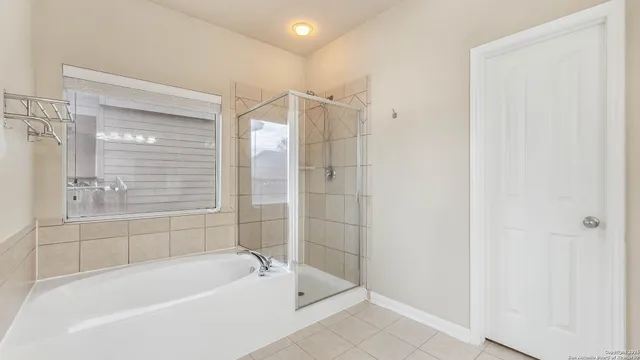 a bathroom with a bathtub and shower