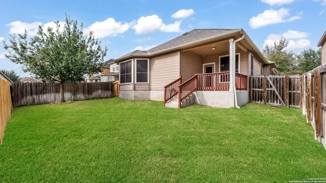 a view of a house with a yard and sitting area