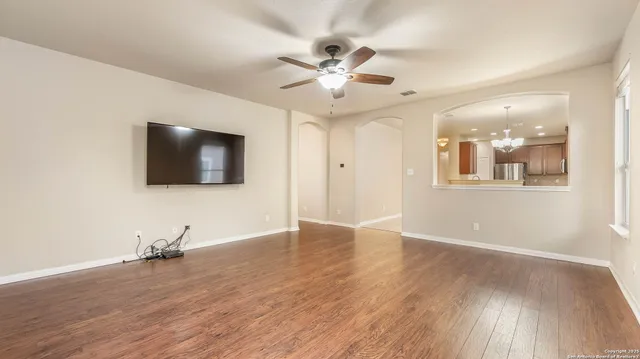 wooden floor in an empty room with a window