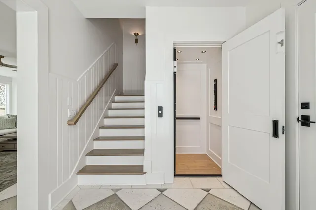 a view of entryway and hall with wooden floor