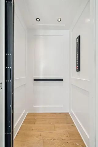 a bathroom with a granite countertop double vanity sink and a mirror