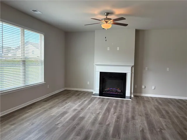 an empty room with a fireplace and a window