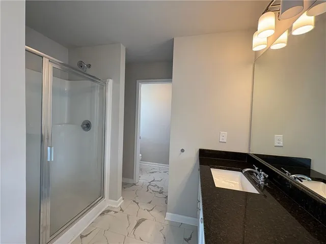 a bathroom with a bathtub and shower