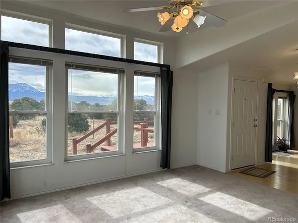 a view of an entryway with a floor to ceiling window and a living room