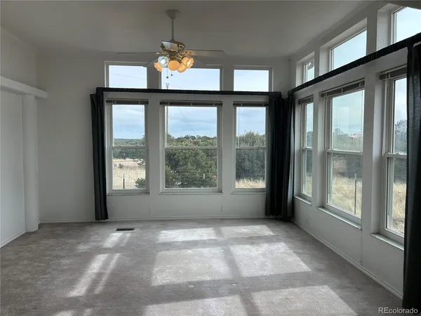 an empty room that has a window and a toilet