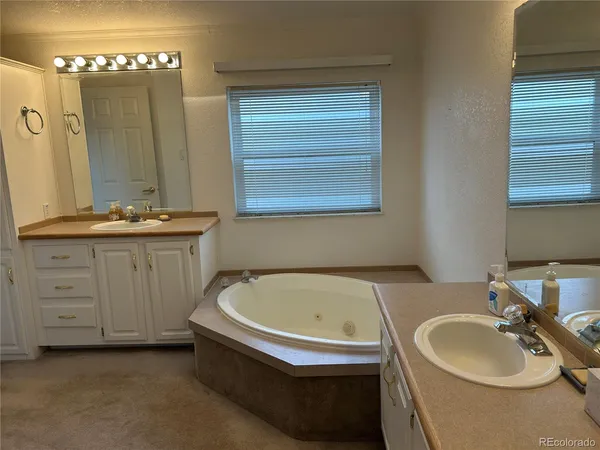 a sink with a stove a washer and dryer next to a window