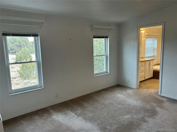 a kitchen with stainless steel appliances granite countertop a stove a sink dishwasher a refrigerator and a dining table with wooden floor