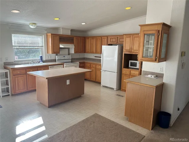 a kitchen with refrigerator and window