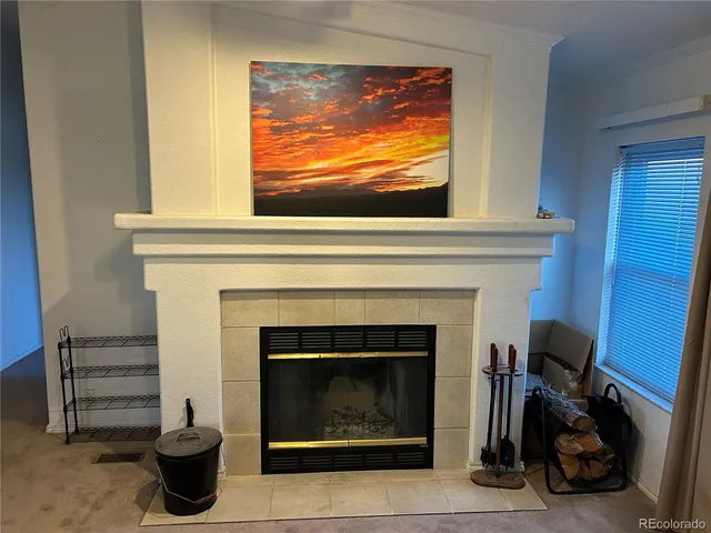 a living room with a fireplace and a flat screen tv