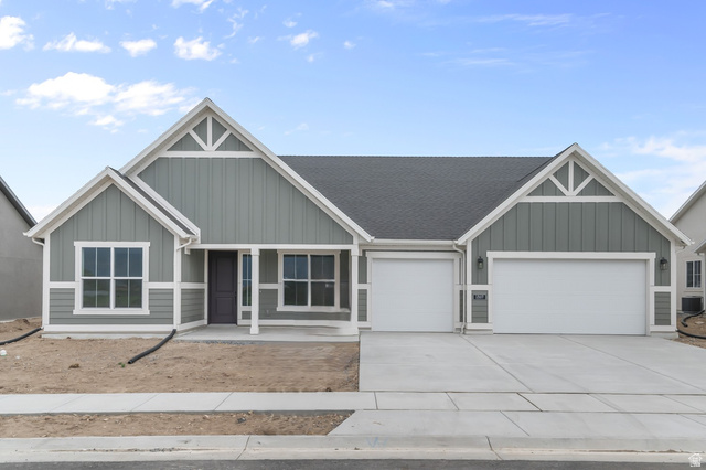 1869 South 2425 West Ogden, UT 84401 - Photo 1 of 22 Craftsman house with a porch, board and batten siding, an attached garage, and concrete driveway