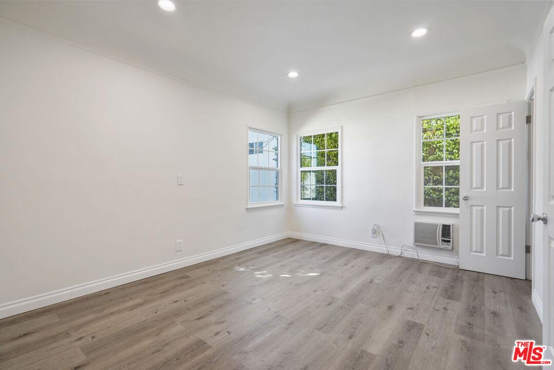228 South Reeves Drive, Unit D Beverly Hills, CA 90212 - Photo 8 of 13 an empty room with wooden floor and windows