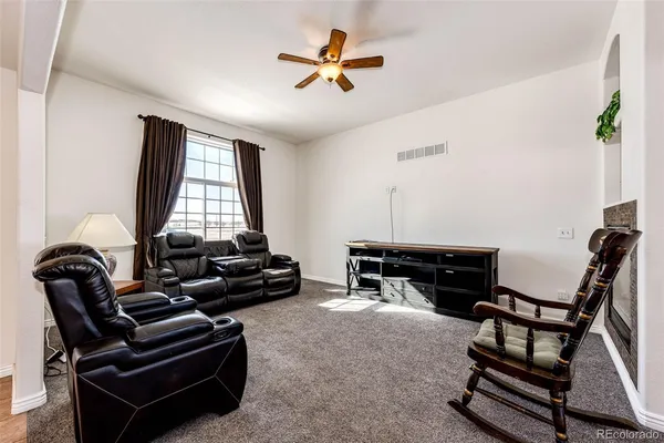 a living room with furniture and a chandelier