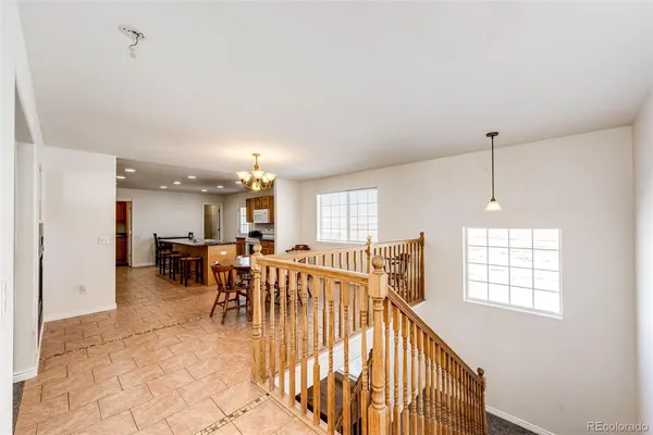 a view of a dining room with furniture and a chandelier