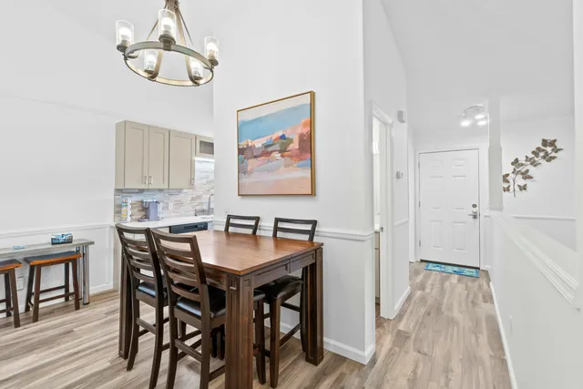 a view of a dining room with furniture wooden floor and a chandelier