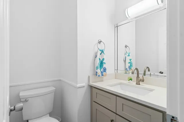 a bathroom with a sink toilet and mirror