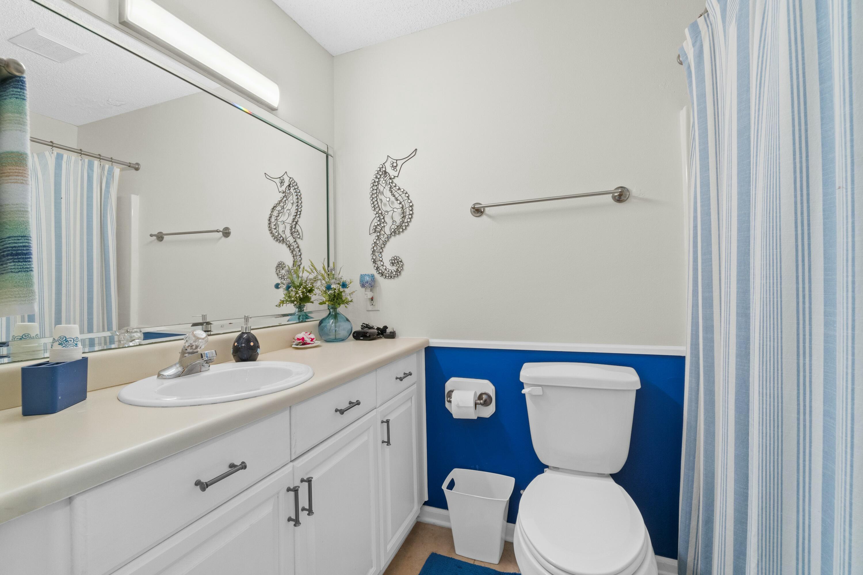 50 Gossamer Lane, Unit 12 Inlet Beach, FL 32461 - Photo 25 of 37 a bathroom with a toilet sink and mirror