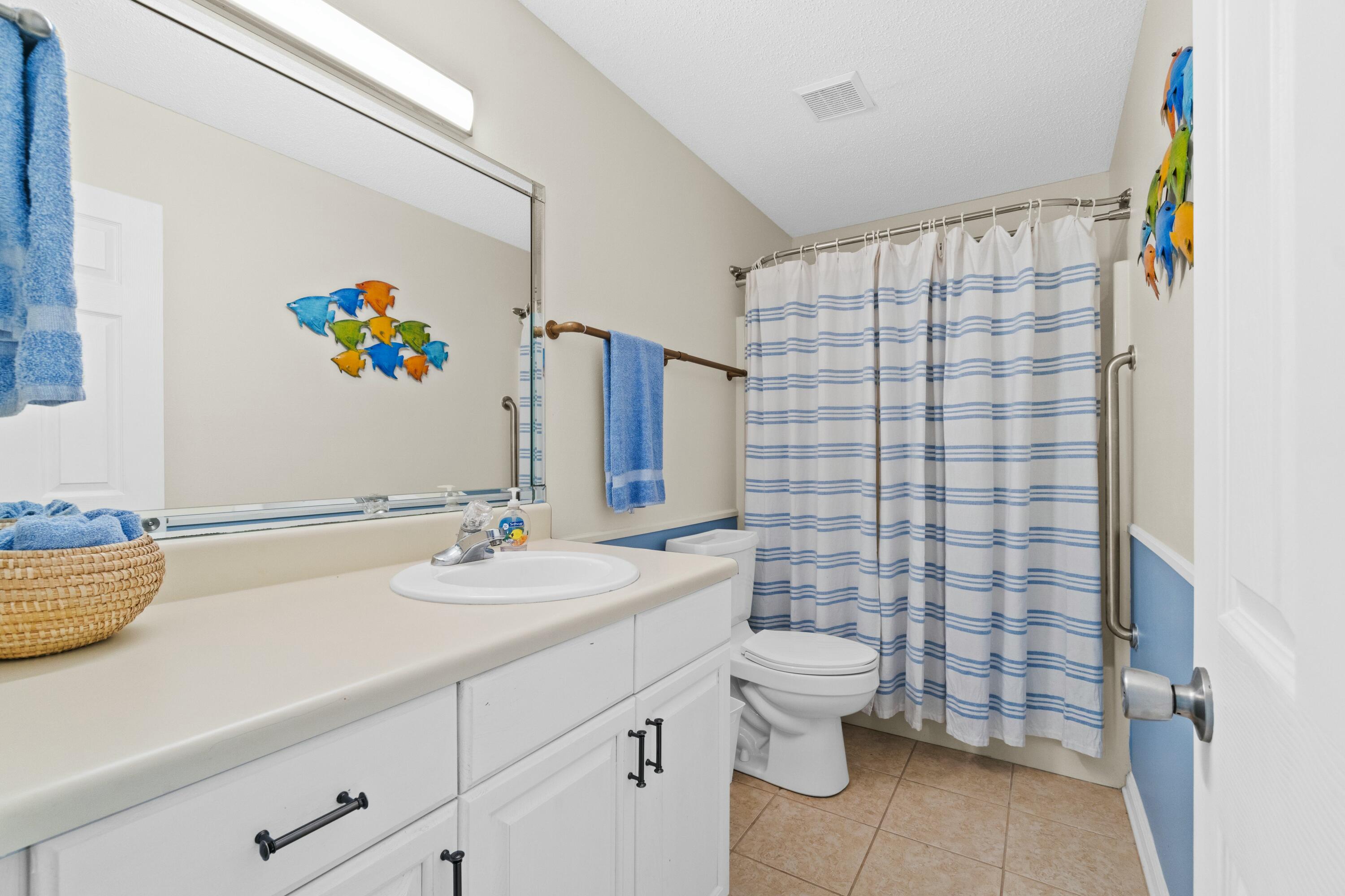 50 Gossamer Lane, Unit 12 Inlet Beach, FL 32461 - Photo 26 of 37 a bathroom with a sink a toilet and a shower curtain