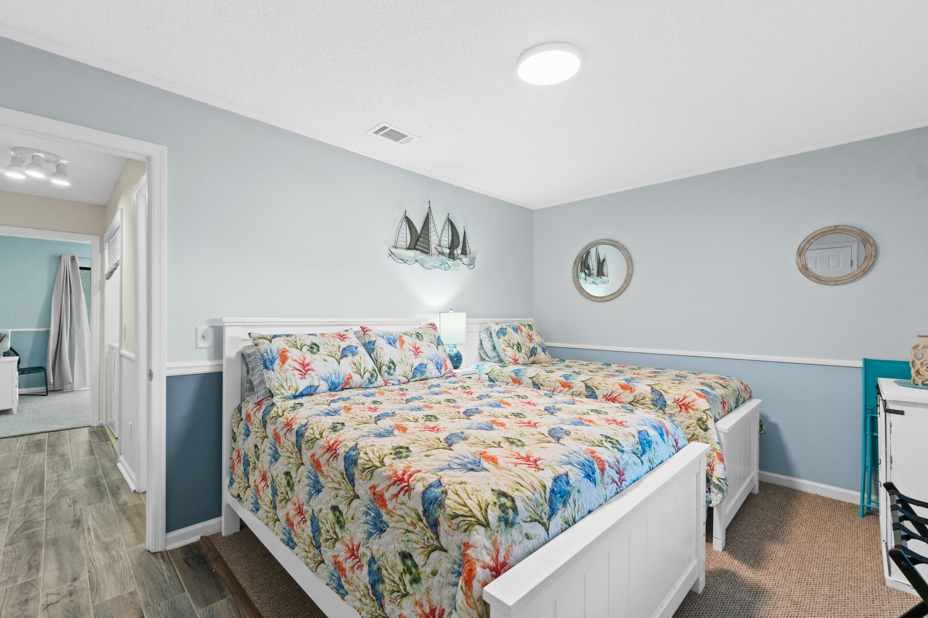 50 Gossamer Lane, Unit 12 Inlet Beach, FL 32461 - Photo 27 of 37 a bedroom with a bed and painting on the wall