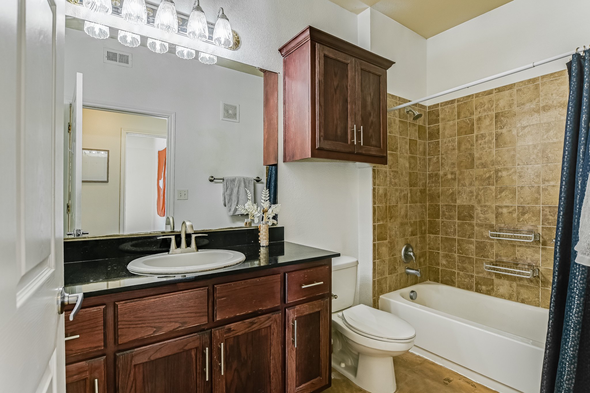 910 West 25th Street, Unit 607 Austin, TX 78705 - Photo 10 of 19 Bathroom featuring vanity, shower / tub combo, and tile patterned flooring