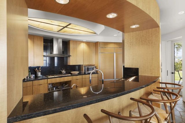 a kitchen with stainless steel appliances granite countertop a refrigerator and a stove top oven