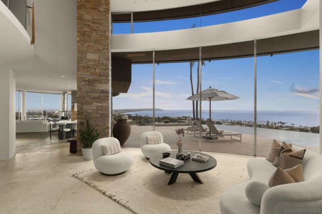 a dining room with furniture and a large window