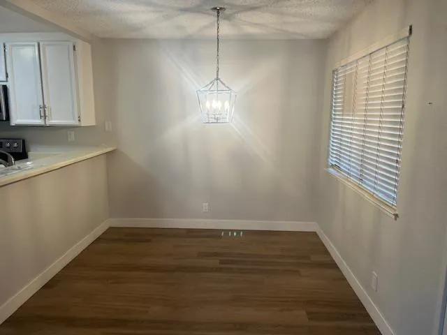 a view of a room with wooden floor and fan