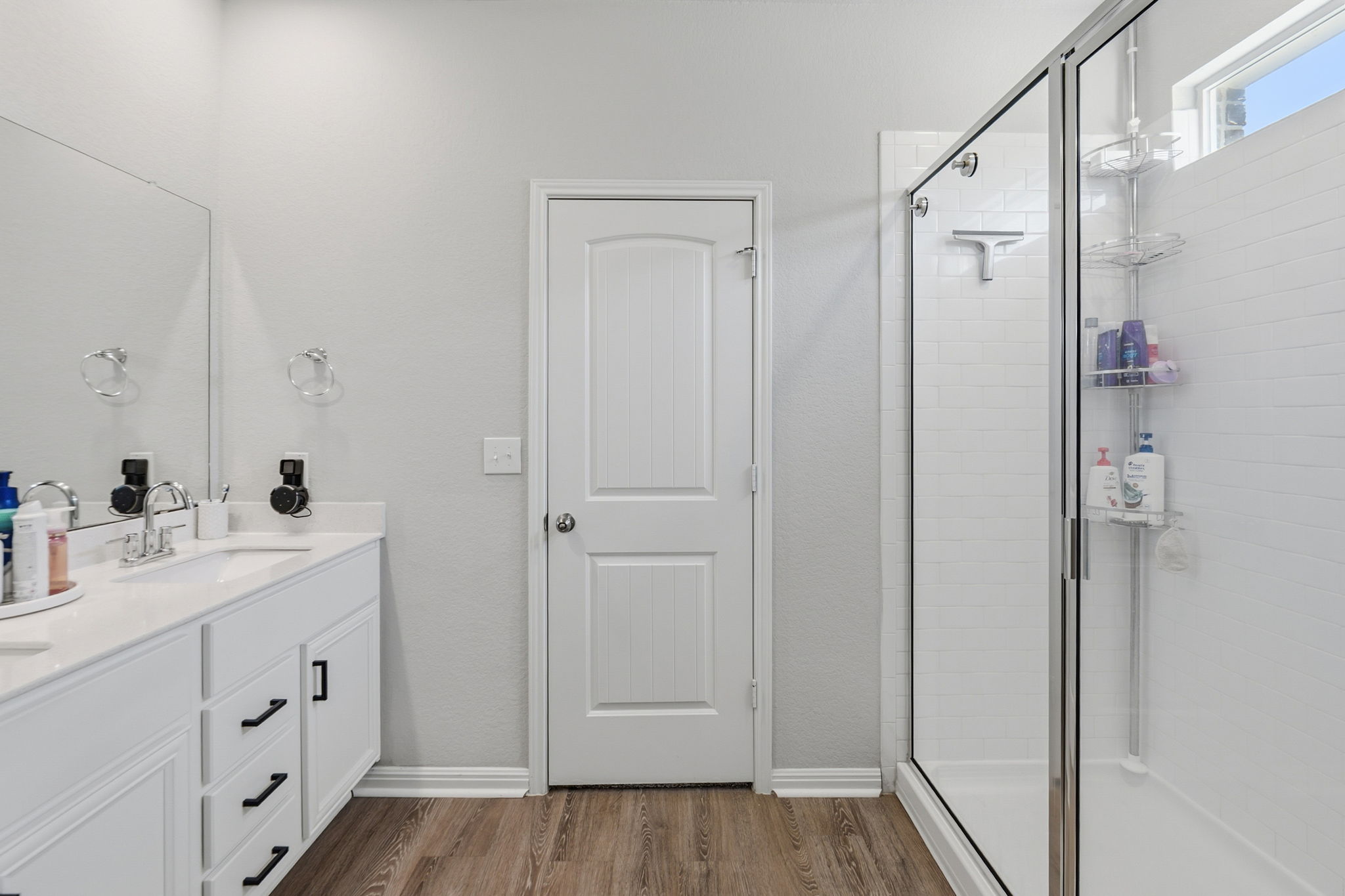 142 Brunnen Way Georgetown, TX 78626 - Photo 14 of 22 A well-lit bathroom features a spacious shower and a wide vanity with ample counter space.