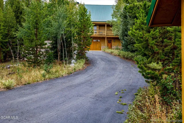 a view of a house with a yard and garage