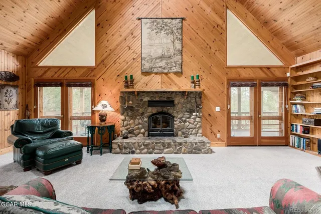 a living room with furniture a fireplace and windows