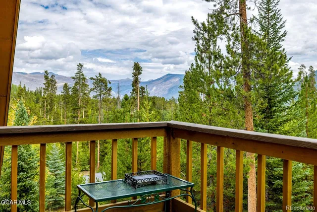 a front view of house with yard and trees around