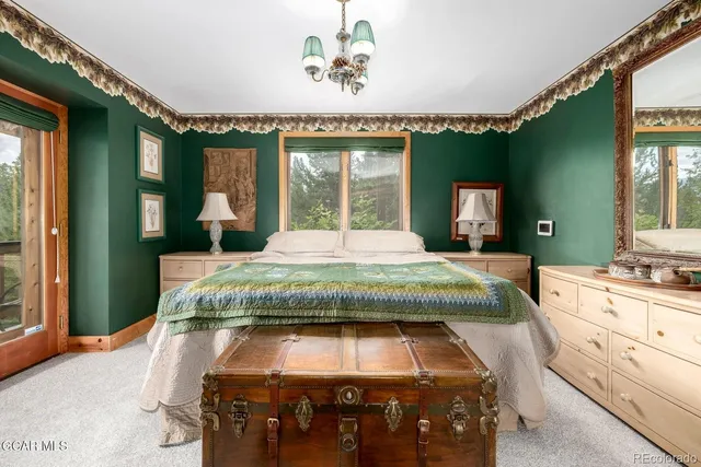 a bedroom with a bed mirror and window