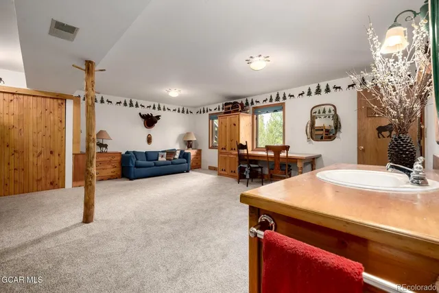 a kitchen that has a lot of cabinets in it and wooden floors