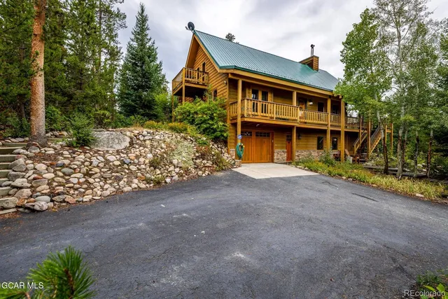 a view of a wooden house with a yard