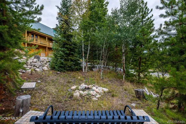 a view of living room with patio furniture and a fireplace