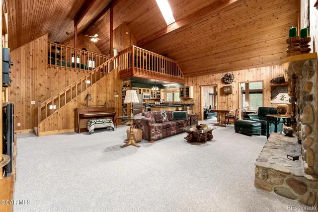 a living room with furniture a fireplace and a large window