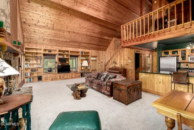 a dining room with furniture a chandelier and a rug