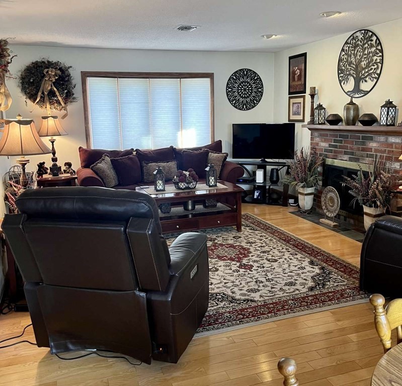 57 Chestnut Circle Suffield, CT 06093 - Photo 27 of 40 a living room with furniture a window and a fireplace