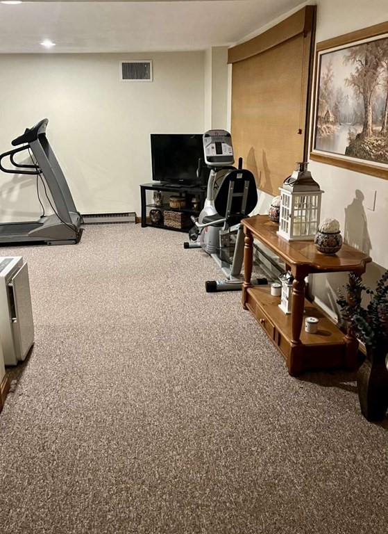 57 Chestnut Circle Suffield, CT 06093 - Photo 36 of 40 a room with gym equipment and a flat screen tv