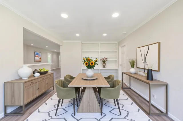 a dining room with furniture and wooden floor