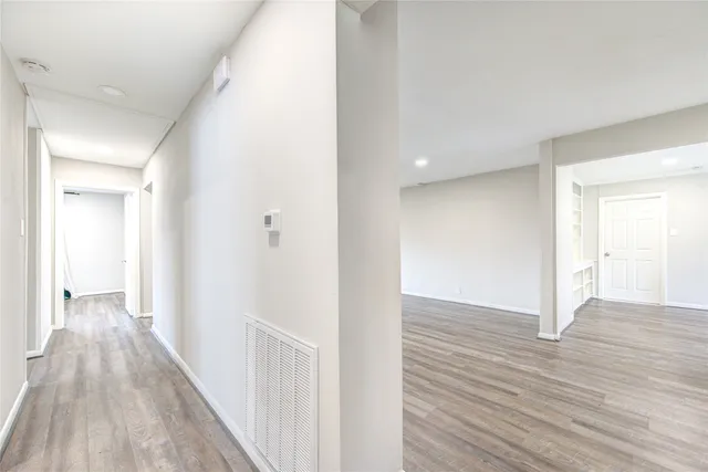 a view of a hallway with wooden floor