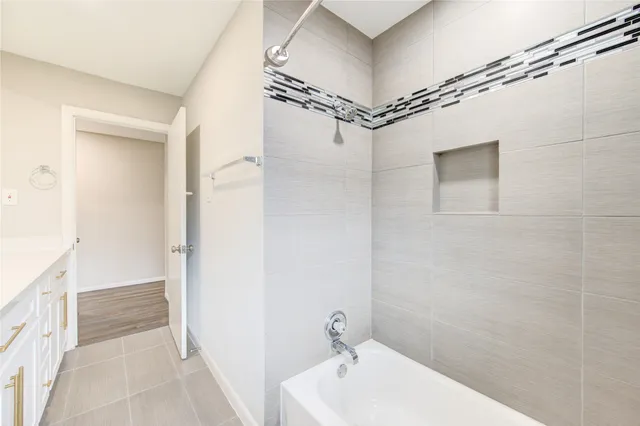 a bathroom with a bathtub and shower