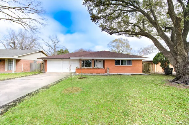 a front view of a house with yard porch and green space