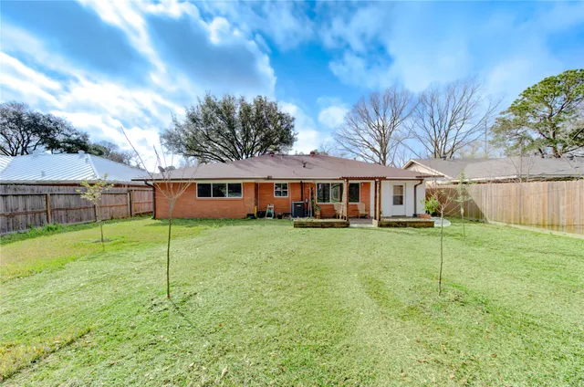 a front view of a house with a yard table and chairs