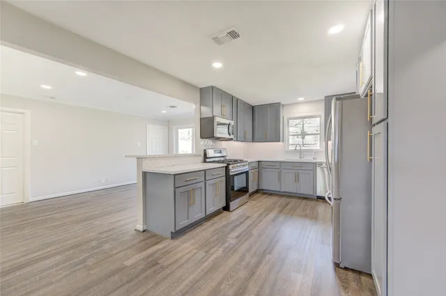 a kitchen with a white wooden floors a sink and a refrigerator