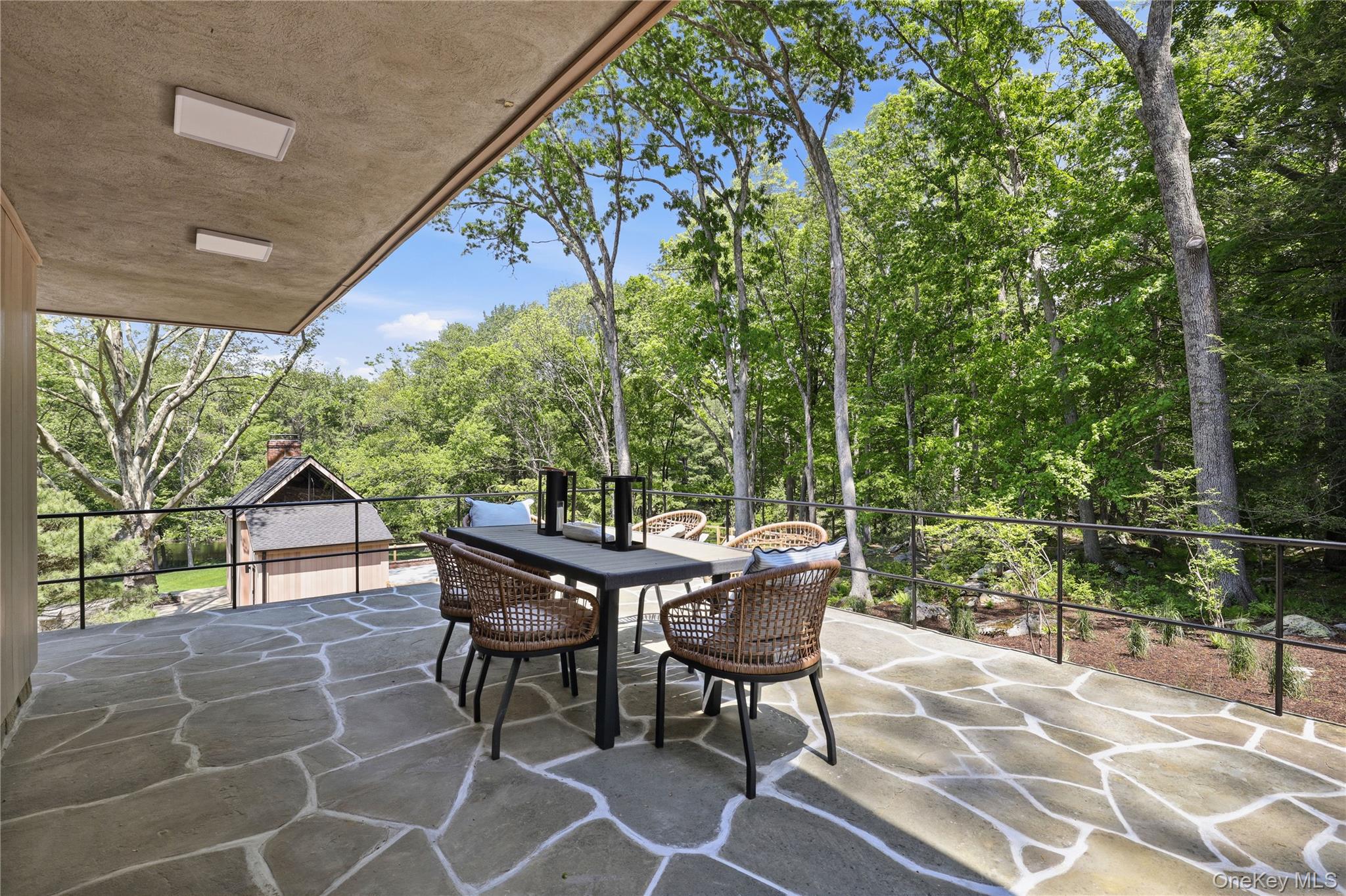 39 Old Snake Hill Road Pound Ridge, NY 10576 - Photo 13 of 37 a view of a patio with table and chairs with wooden floor and fence